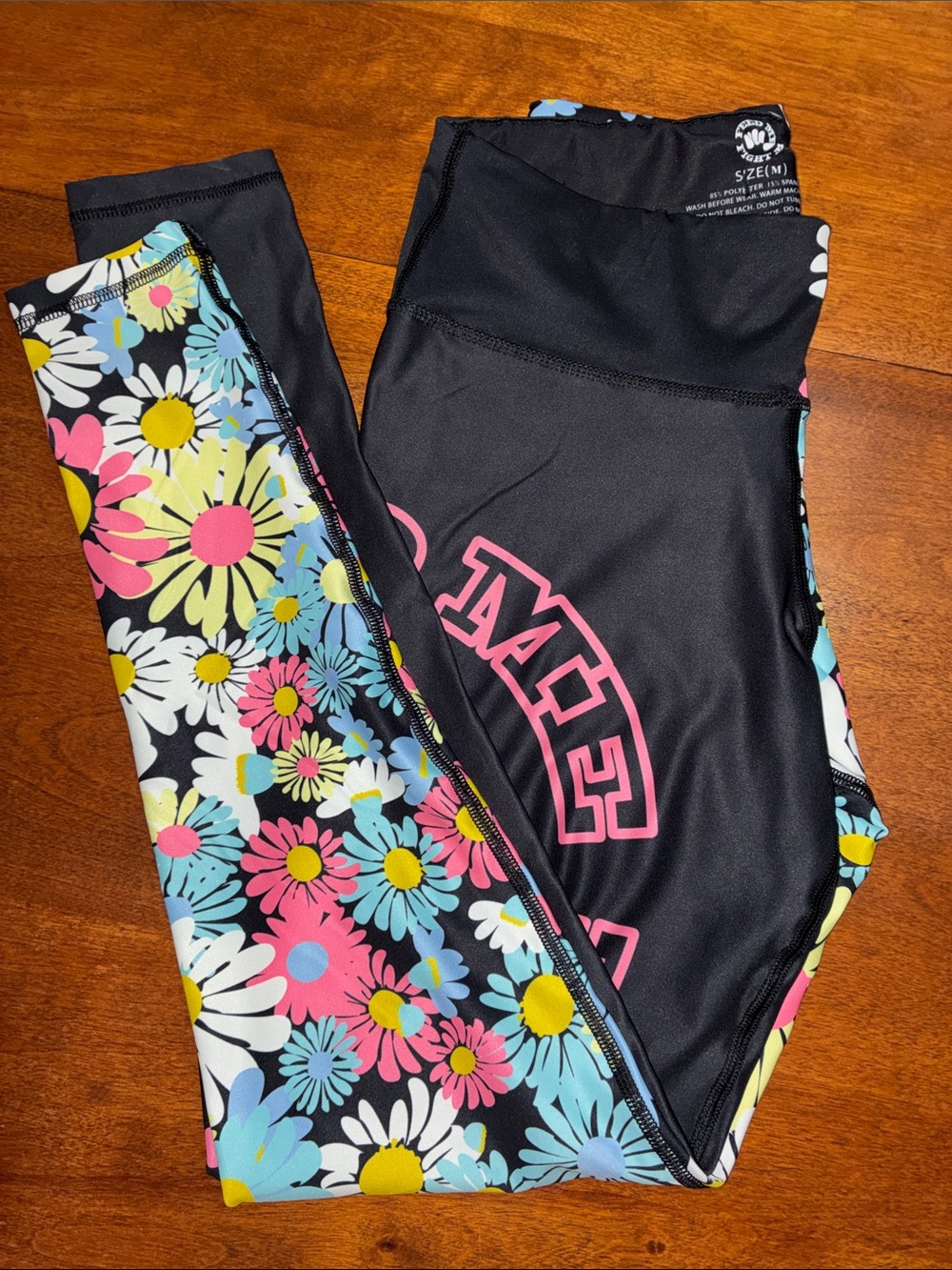Feed Me Fight Me Black and Floral Leggings with Pink Logo. NO pockets.